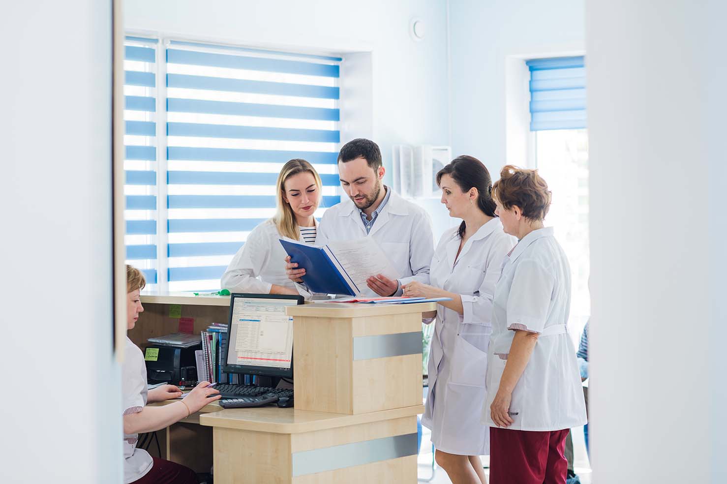 Doctor and receptionist at reception in a hospital.